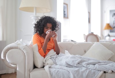 A person sneezing who has allergies, and needs seasonal allergies natural remedies. 